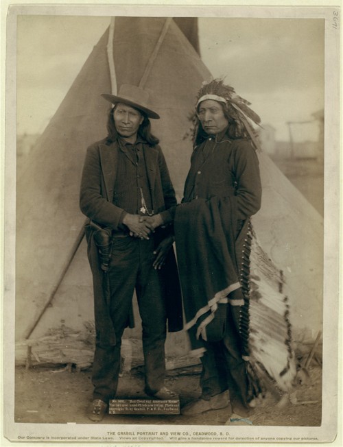 Red Cloud and American Horse – two of the most renowned Ogala chiefs – are seen clasping hands in front of a tipi on the Pine Ridge Reservation in South Dakota. Both men served as delegates to Washington, D.C., after years of actively fighting the American government. John C. Grabill, 
